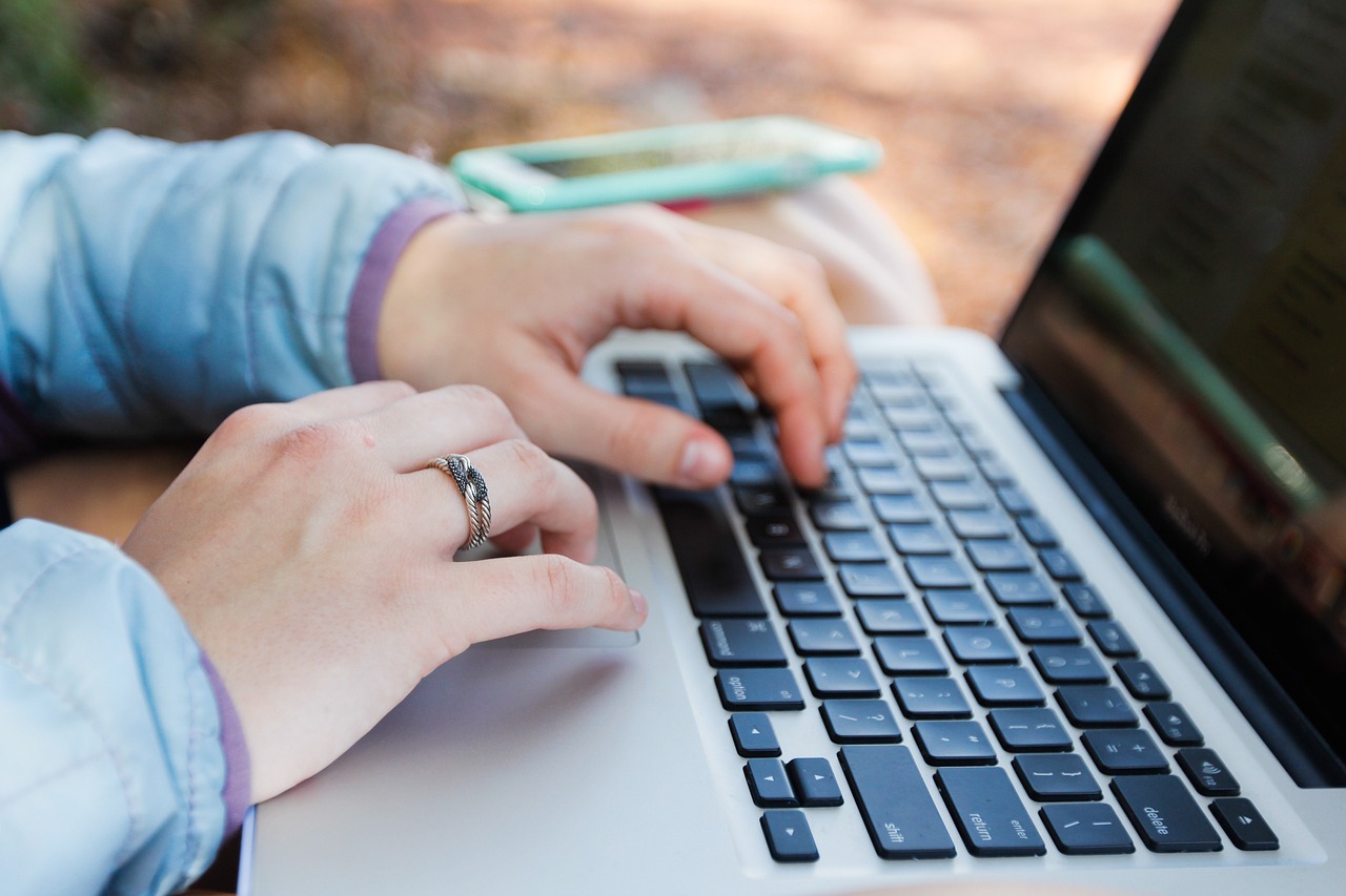 Hands at a computer keyboard